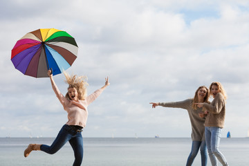 Women making fun of jumping friend