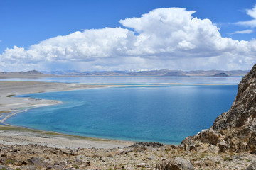 Fototapeta na wymiar China, Tibet. Holy lake Tery Tashi Nam Co in summer cloudy day