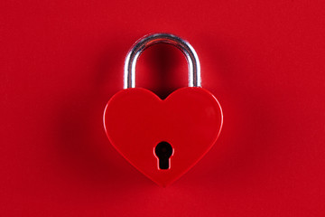 The lock in the form of a heart on a red background