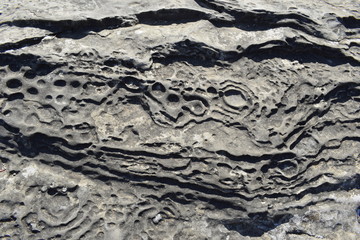 Textura suelo de piedra gris con hendiduras redondas