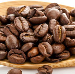 Coffee Beans. Close-up, clear grain structure. Coffee on a wooden spoon.