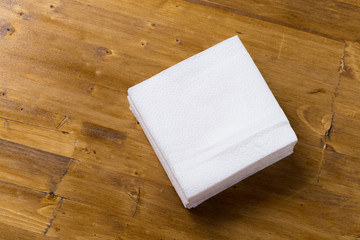 paper napkin on wooden background.