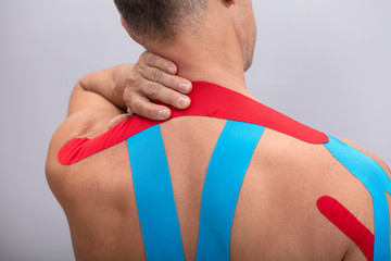 Rear View Of Man With Physio Tape