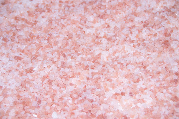Texture sea pink salt. Useful spa treatments. Pink salt granules.
