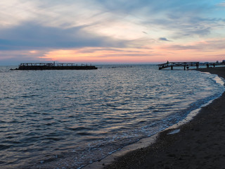 Obraz premium Clouds at sunset above the pier and blue sea, Ostia, Rome, Italy