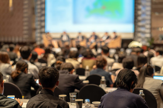 Rear view of Audience listening Speakers on the stage in the conference hall or seminar meeting, business and education about investment concept