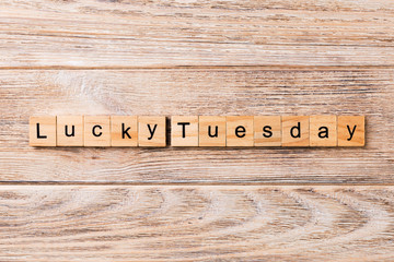 Lucky Tuesday word written on wood block. Lucky Tuesday text on wooden table for your desing, concept