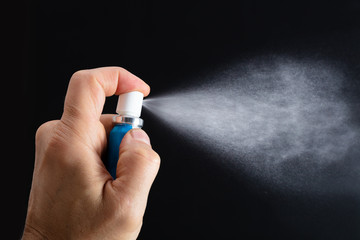 Person Spraying Breath Freshener