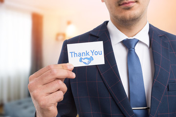 Salesman showing gratitude with business card.