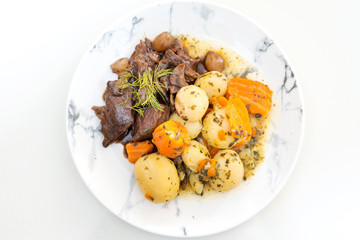 Beef meat stewed with potatoes-Traditional French cuisine Beef Bourguignon potatoes carrots in persillade