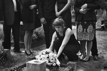 Lonely widower mourning at the graveyard