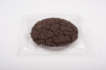 Oatmeal cookie in a plastic pack on a white