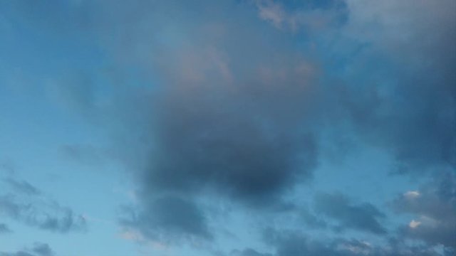 Timelapse of dark blue sky with light blue clouds and other evanescent