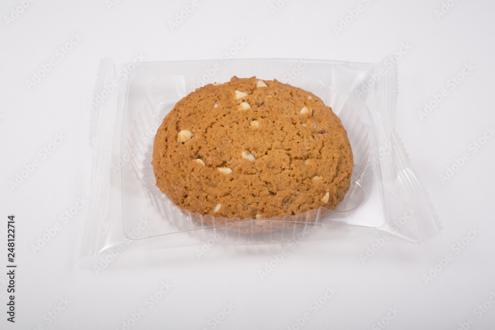 Wall mural oatmeal cookie in a plastic pack on a white