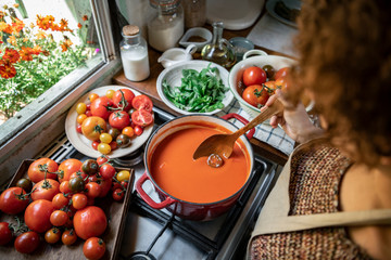 Homemade tomato soup cooking in the kitchen