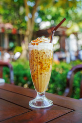 iced coffee float with caramel on top on blurred background