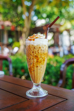 iced coffee float with caramel on top on blurred background