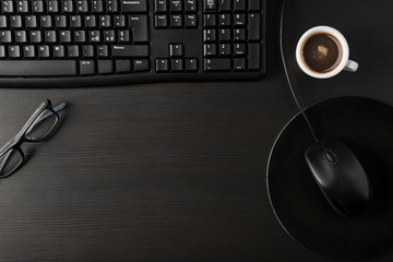 Total black desk with desktop and cup of coffee