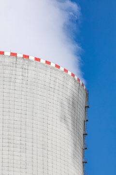 Steam Going Out Of A Cooling Tower Of A Nuclear Power Plant Into Blue Sky