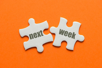 The word Next week on two matching puzzle on orange background