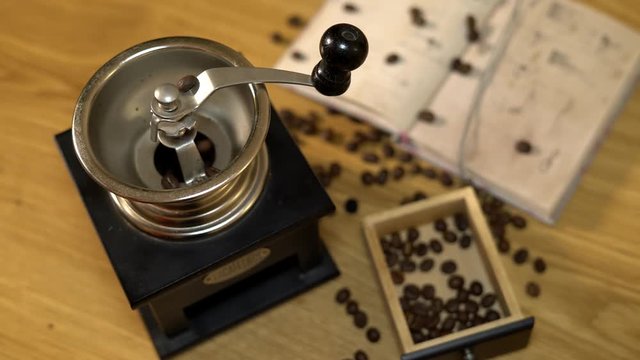 Brown Coffee beans are pured in the old manual coffee grinder. 4K