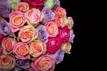 Beautiful bouquet of roses in a gift box. Bouquet of pink roses. Pink roses close-up. on black background, with space for text.