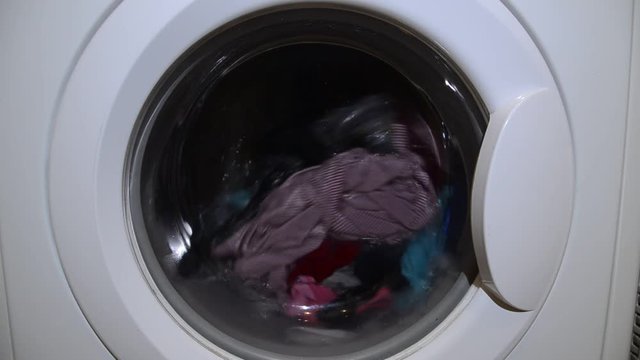 Washing machine drum washes colorful clothes