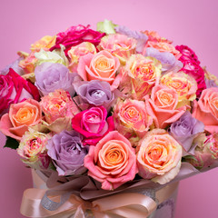 Beautiful bouquet of roses in a gift box. Bouquet of pink roses. Pink roses close-up. on pink background, with space for text.