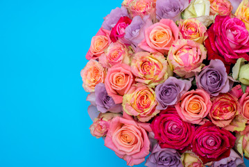 Beautiful bouquet of roses in a gift box. Bouquet of pink roses. Pink roses close-up. on blue background, with space for text.