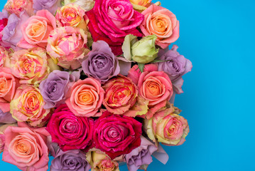 Beautiful bouquet of roses in a gift box. Bouquet of pink roses. Pink roses close-up. on blue background, with space for text.