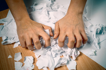 hands tear paper. overstrain, nerves, psychosis