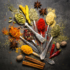 Set of various spices  on black stone background.