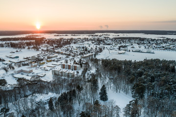 Aerial view of a beautiful sunset in the winter forest. 