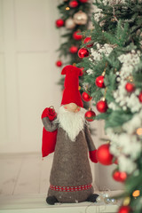 Fototapeta premium Christmas background with xmas tree, on a wooden white background. Merry christmas card. Winter holiday theme. Happy New Year. Space for text.