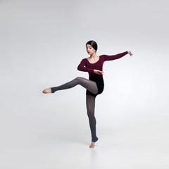 young beautiful dancer in beige swimsuit