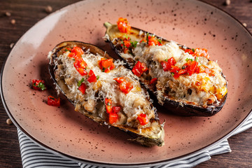 European Spanish cuisine. Baked eggplants with meat and vegetables, parmesan cheese. White wine on the table. Close-up background image. Beautiful serving dishes in the restaurant.