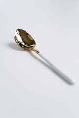 New luxury Golden cutlery view from above on a isolated white background. Top view. White spoon for a festive table for a wedding, birthday or party.