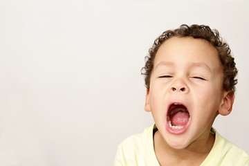 little boy yawning with textured background