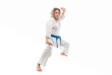 Full body of woman making martial arts pose wearing white outfit © Catalin Pop