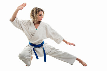 Full body of woman making martial arts pose wearing white outfit © Catalin Pop