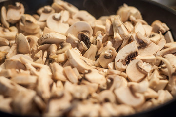 Juicy beautiful sliced mushrooms in a pan