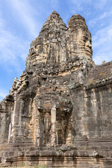 Fototapeta premium carved faces on South Gate of Angkor Thom, Siem Reap, Cambodia, Asia