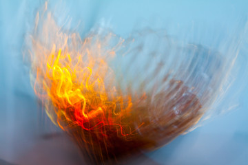 Abstract blurred light effect of orange waves on a blue background. Long exposure photo of moving camera