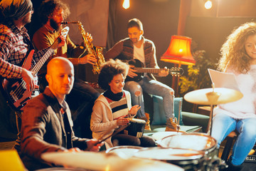 Multicultural jazz band practicing for the gig in home studio.