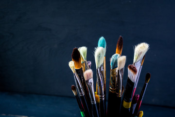 Row of artist paint brushes background