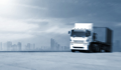 Obraz na płótnie Canvas Blurred movement big trucks speeding on the highway - Transport industry concept , big truck containers