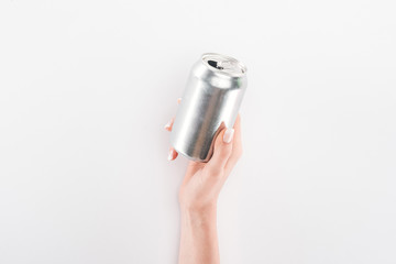 Partial view of woman holding empty can on grey background