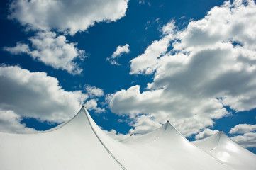 White Tent Top Against a Cloudy Sky