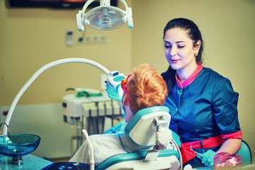 Dentist examining a patient's teeth in the dentist.