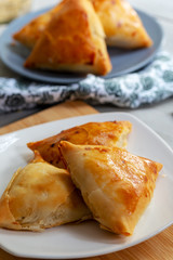 Puff pastry triangles filled minced meat, onion and spices